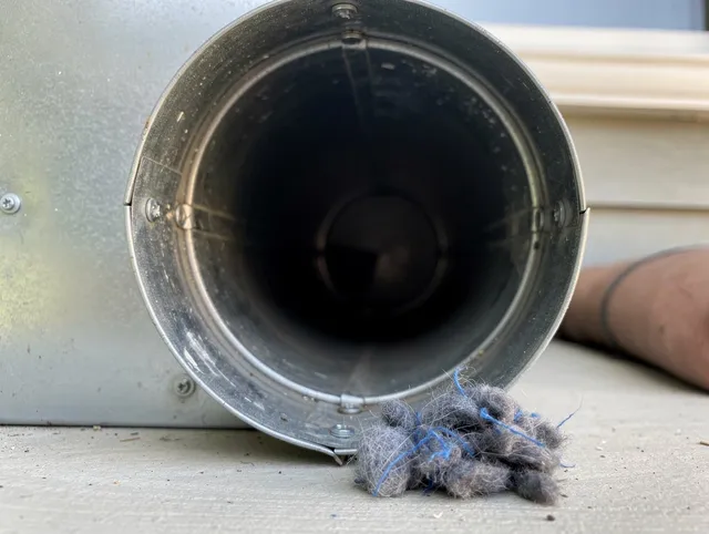 Hull Dryer Vent Cleaning technician using specialized equipment to clear severe dryer vent blockage in Hull